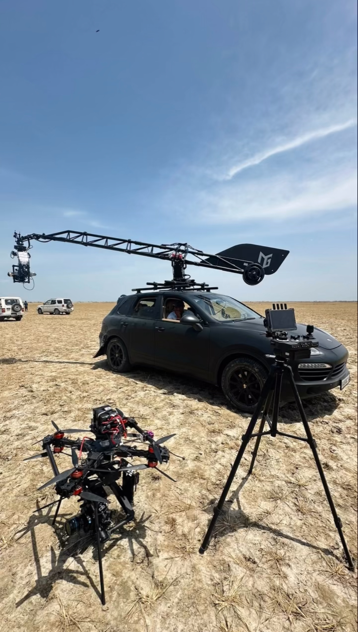 Heavy-lift drone + crane vehicle on desert location